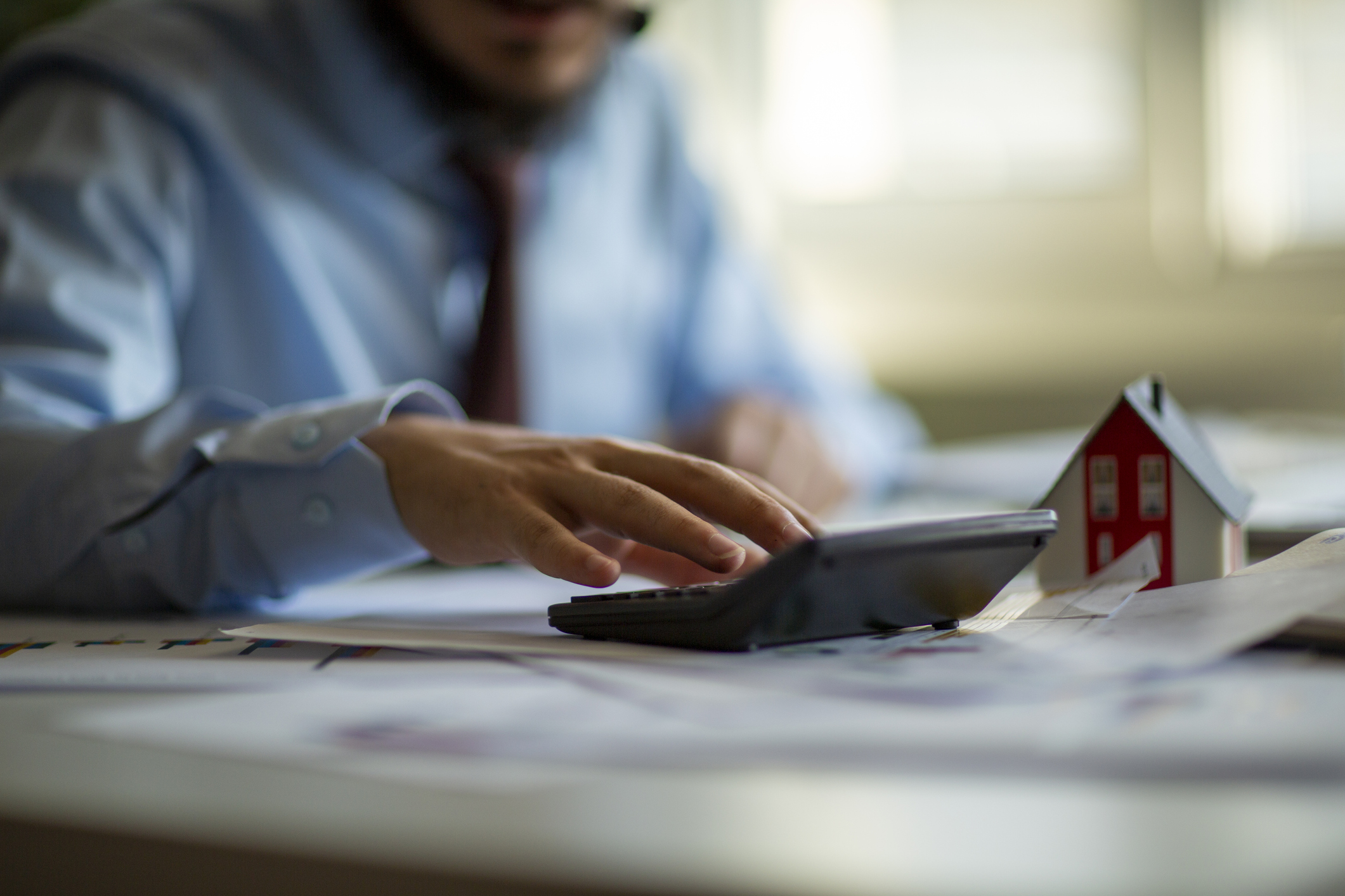 Business accounting concept, Business man using calculator with computer laptop, budget and loan paper in office.